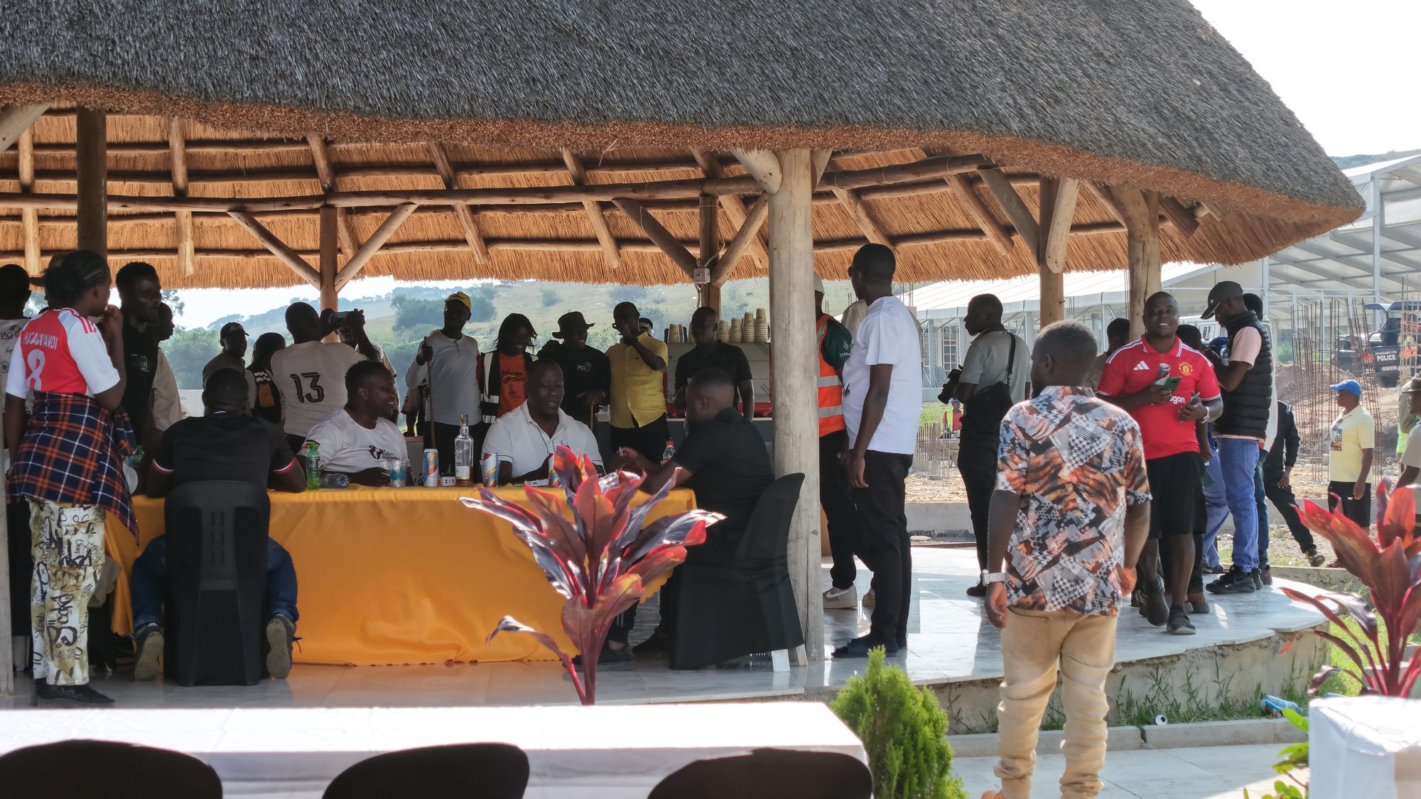 Guests gathered under the lakeside hospitality pavilion at Nyabihoko