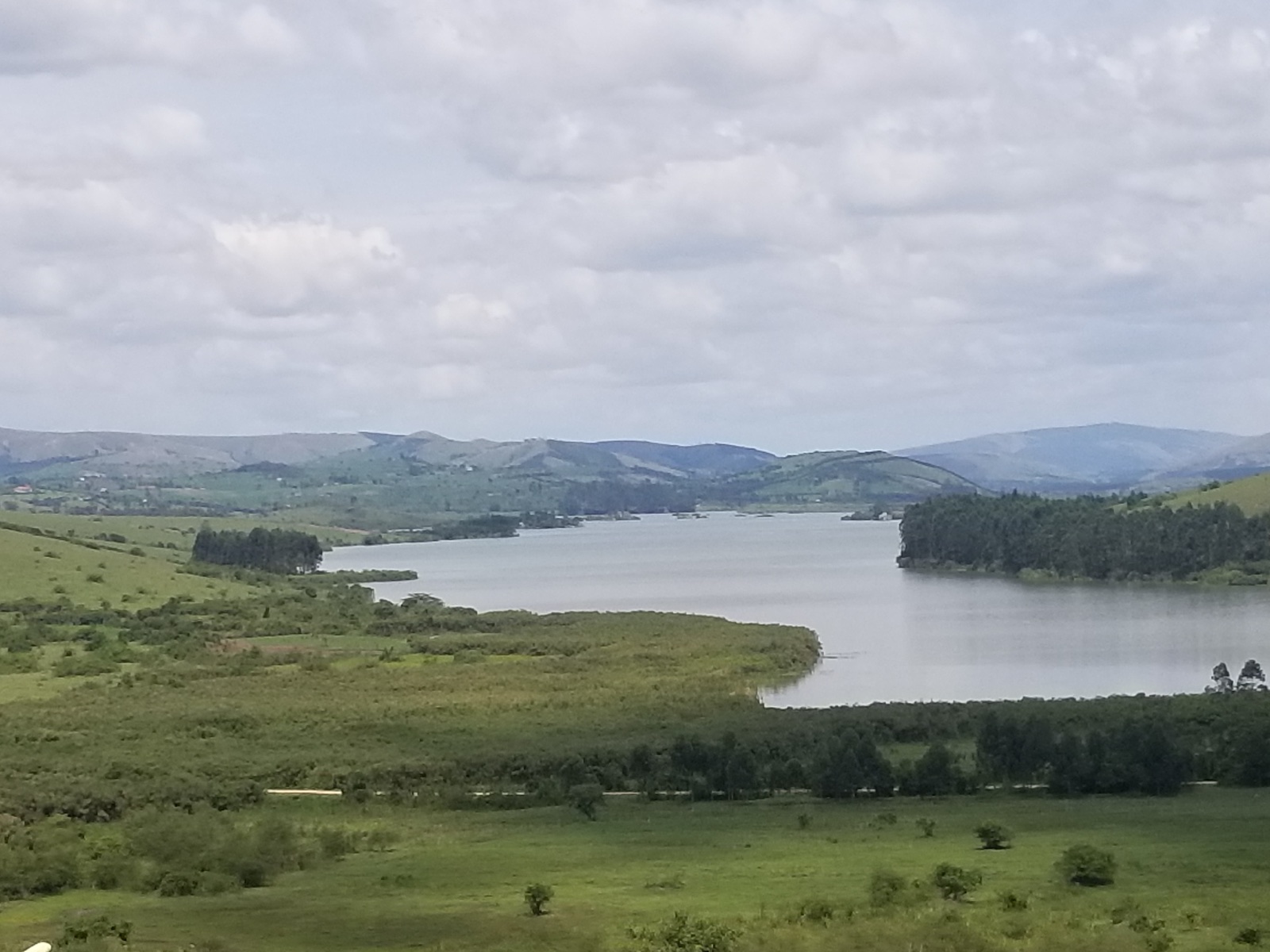 Scenic Lake Nyabihoko surrounded by hills and farmland, Uganda