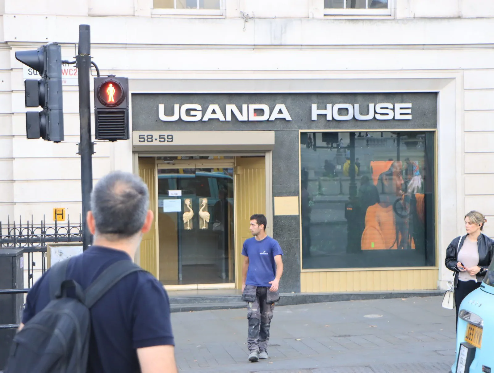 The Uganda House entrance on Trafalgar Square in London: a stone building with a dark UGANDA HOUSE fascia and the number 58-59 above the door.