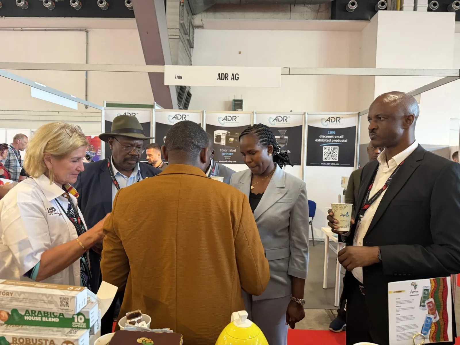 Hon. Desire Muhooza and Uganda Coffee representatives in conversation at the booth